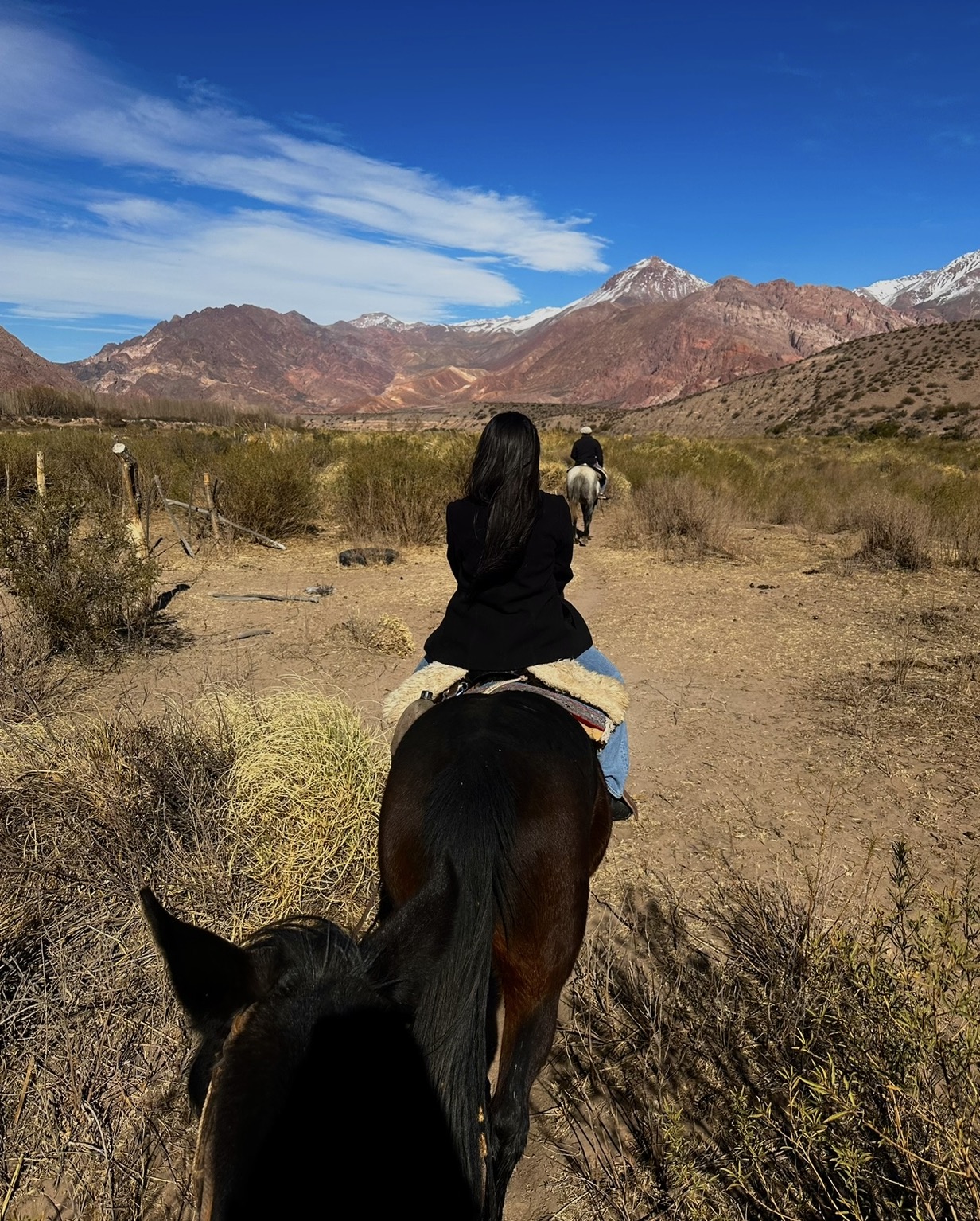 Daiana horseback riding in the mountains
